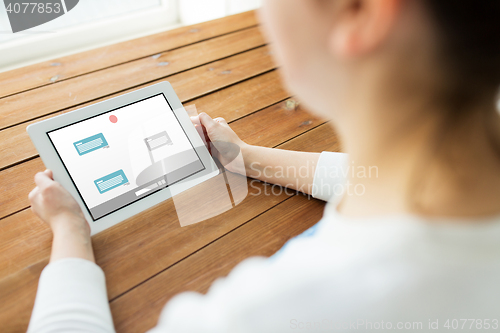 Image of close up of woman with tablet pc chatting