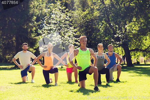 Image of group of friends or sportsmen exercising outdoors