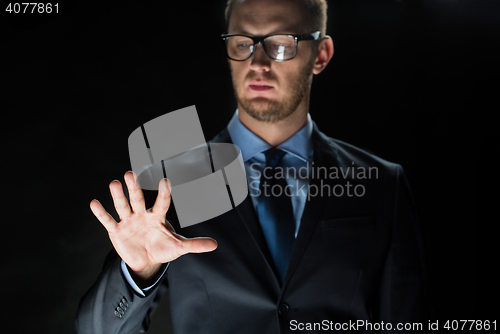 Image of close up of businessman touching virtual screen