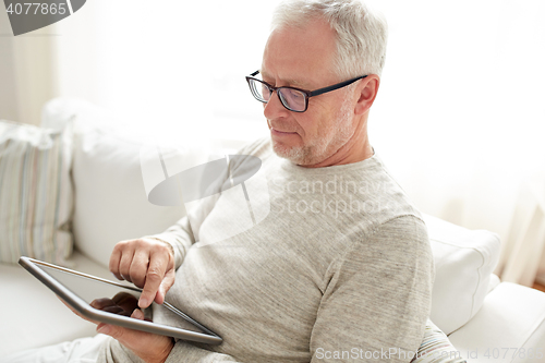 Image of senior man with tablet pc at home