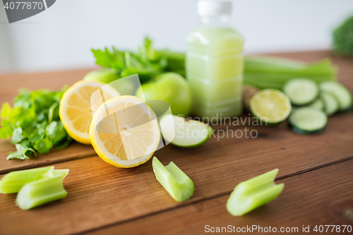 Image of close up of bottle with green juice and vegetables