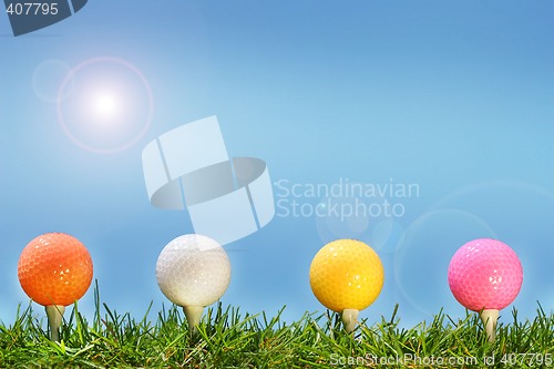 Image of Colored golf balls in the grass