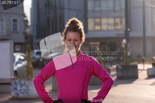 Image of woman  stretching before morning jogging