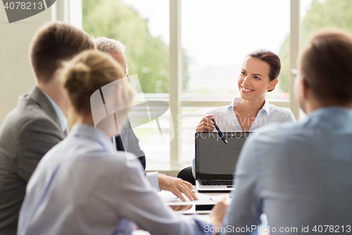 Image of business people with laptop meeting in office