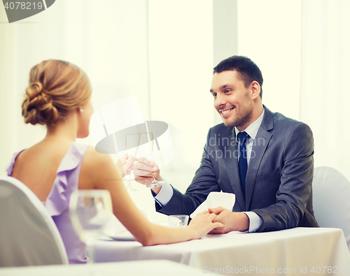 Image of couple with glasses of champagne at restaurant