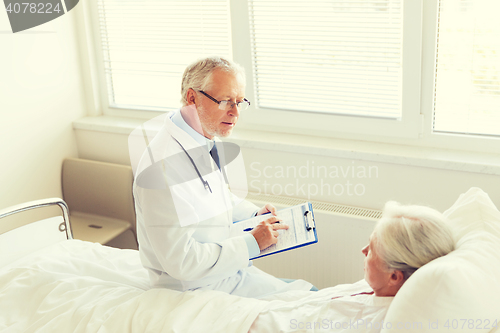 Image of senior woman and doctor with clipboard at hospital