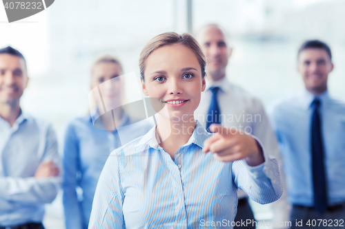 Image of smiling businesswoman pointing finger on you