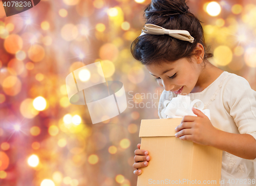 Image of smiling little girl with gift box