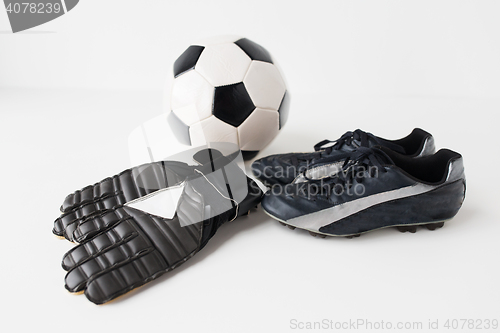 Image of close up of soccer ball, football boots and gloves