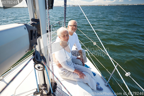 Image of senior couple hugging on sail boat or yacht in sea