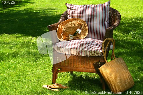 Image of Straw hat and old wicker chair