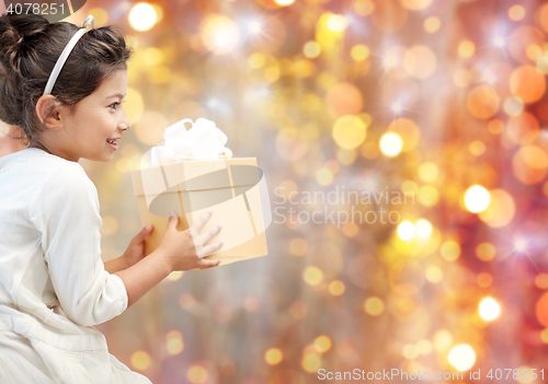 Image of smiling little girl with gift box