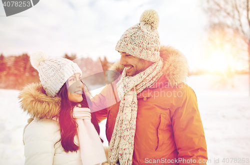 Image of happy couple walking over winter background