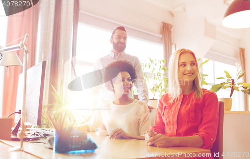 Image of happy creative team in office