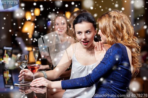 Image of happy women with drinks at night club