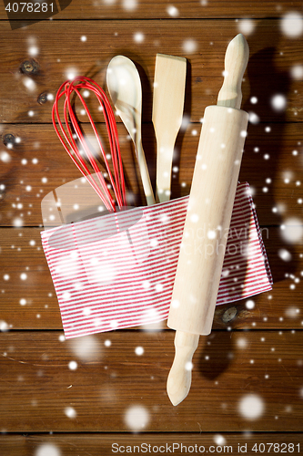 Image of close up of kitchenware for baking on wooden board