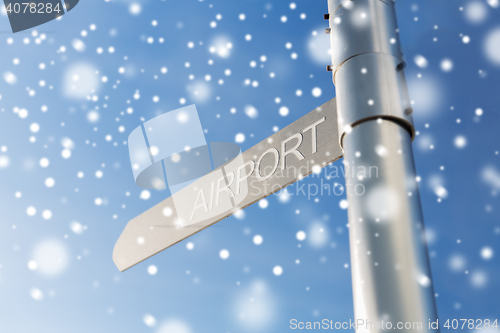 Image of close up of airport signpost over blue sky