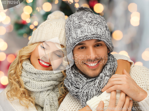 Image of happy family couple in winter clothes hugging