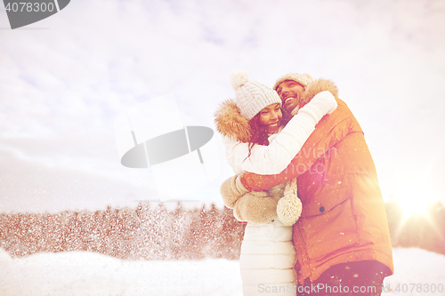 Image of happy couple hugging and laughing in winter