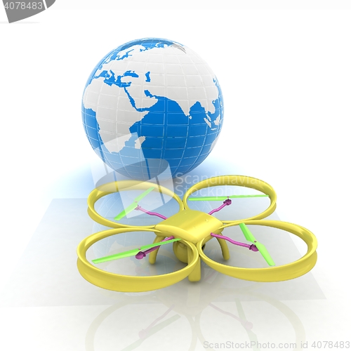 Image of Quadrocopter Drone with Earth Globe and remote controller on a w