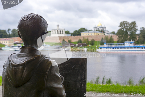 Image of Sculpture of painter boy on river shore