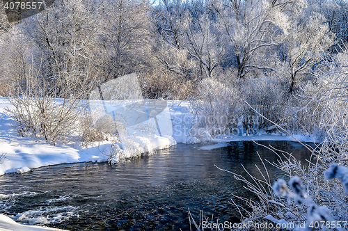 Image of Winter sunny landscape with river and forest