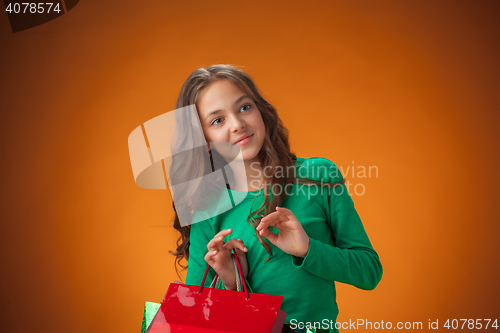 Image of The cute cheerful little girl with shopping bags