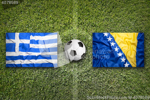 Image of Greece vs. Bosnia and Herzegovina flags on soccer field