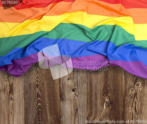 Image of Rainbow flag on wooden background 