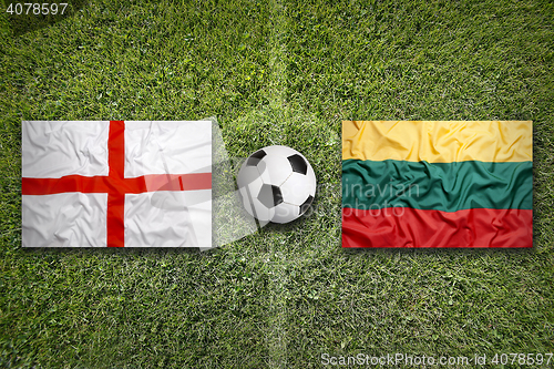 Image of United Kingdom vs. Lithuania flags on soccer field