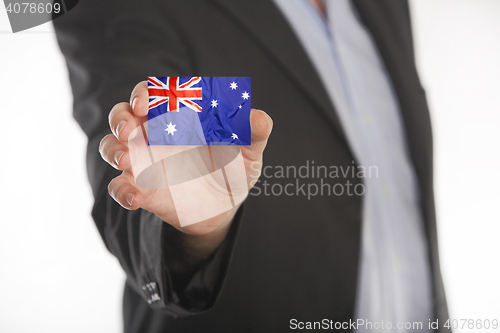 Image of Businessman holding business card with Australian flag