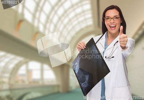 Image of Happy Female Doctor or Nurse Holding X-ray Inside Hospital.