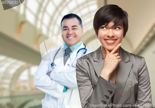 Image of Male Doctor Stands Behind Woman Looking To Side Inside Hospital