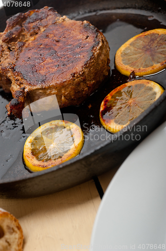 Image of pork chop seared on iron skillet