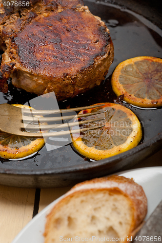 Image of pork chop seared on iron skillet