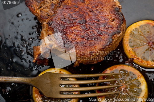 Image of pork chop seared on iron skillet