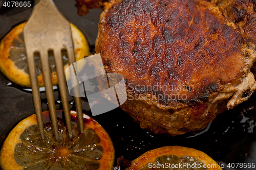 Image of pork chop seared on iron skillet