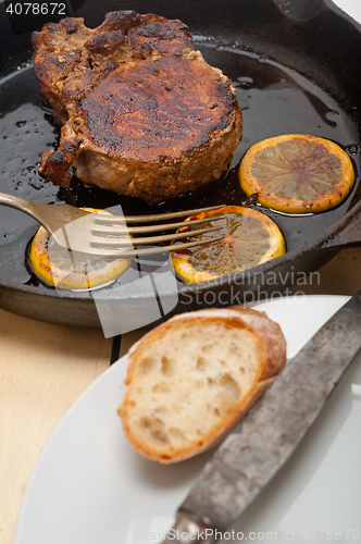 Image of pork chop seared on iron skillet