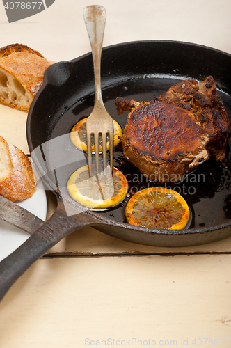 Image of pork chop seared on iron skillet