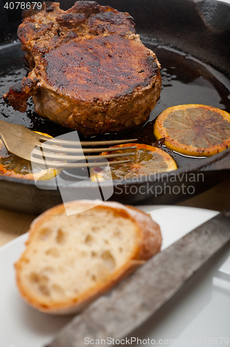 Image of pork chop seared on iron skillet