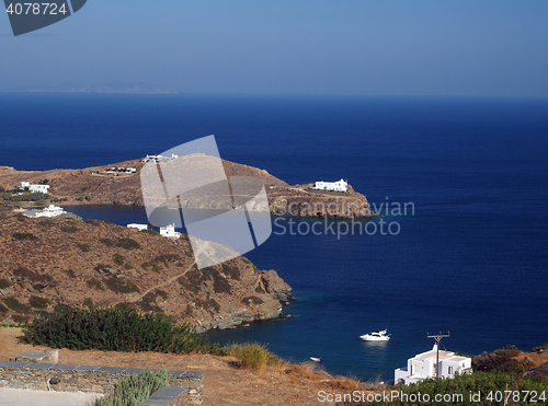 Image of church monastery on promontory in Aegean Sea with houses and boa