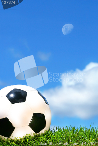 Image of Closeup of a soccerball against a blue sky