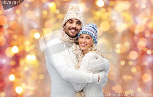 Image of smiling couple in winter clothes hugging