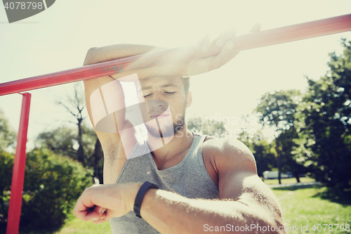 Image of man with heart-rate watch exercising outdoors