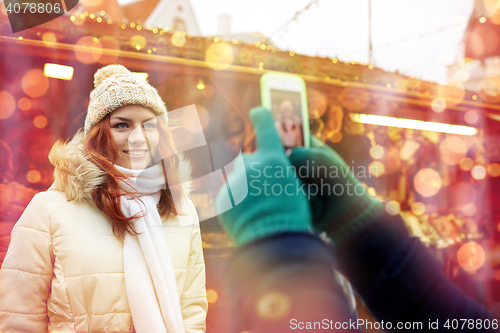 Image of couple taking selfie with smartphone in old town