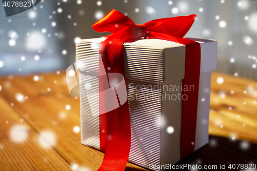 Image of close up of christmas gift box on wooden table