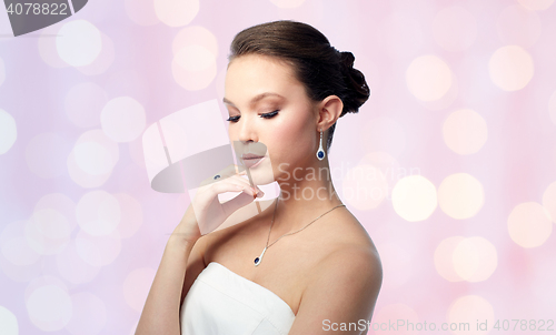 Image of beautiful woman with earring, ring and pendant