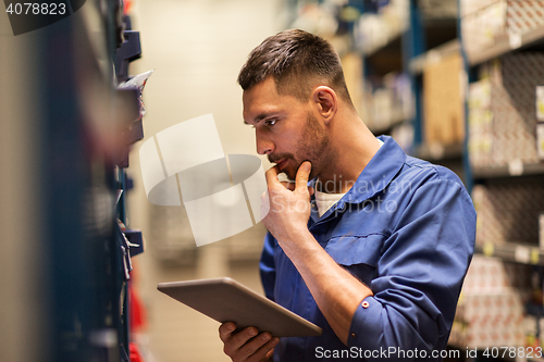 Image of auto mechanic or smith with tablet pc at workshop