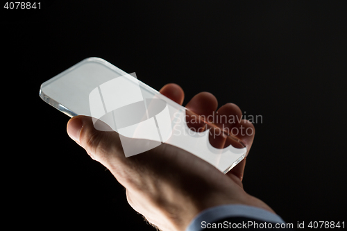 Image of close up of businessman with glass smartphone