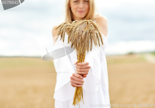 Image of close up of happy woman with cereal spikelets